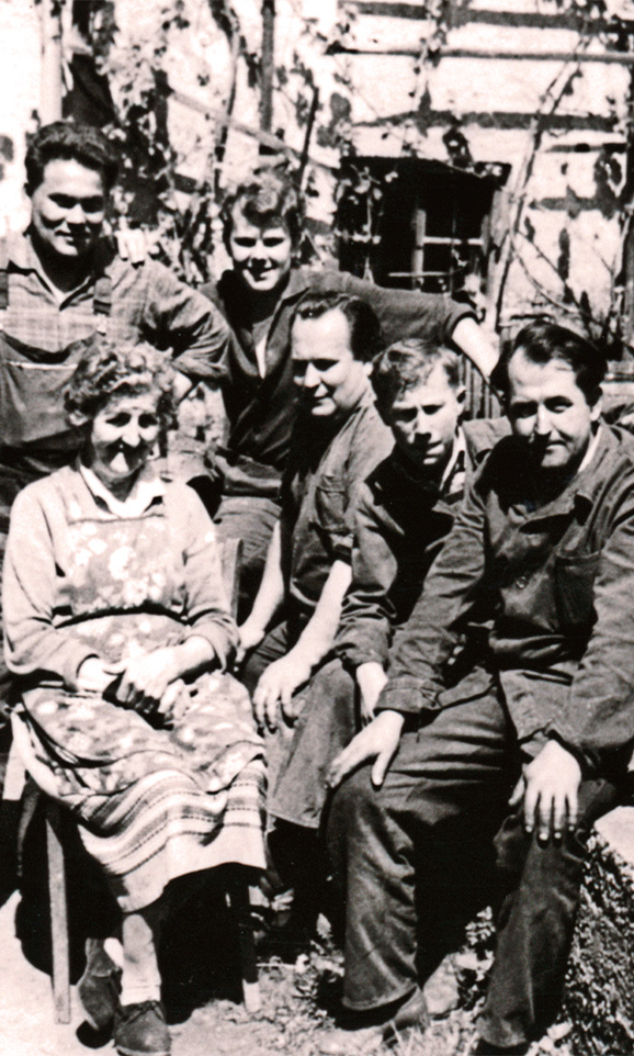 Historic black-and-white photo of employees from the early company history.